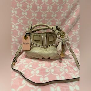 Juicy Couture Cream Crossbody Satchel with Bow Charm and Gold Accents